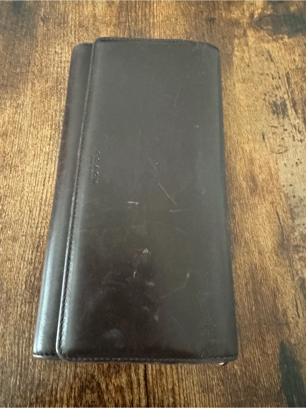 Dark Brown Coach Wallet with lots of card space, never used but has scratch